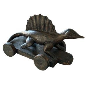 Vintage Wood Carved Black With Red Undertone Stain Dimetrodon Dinosaur On Wheels